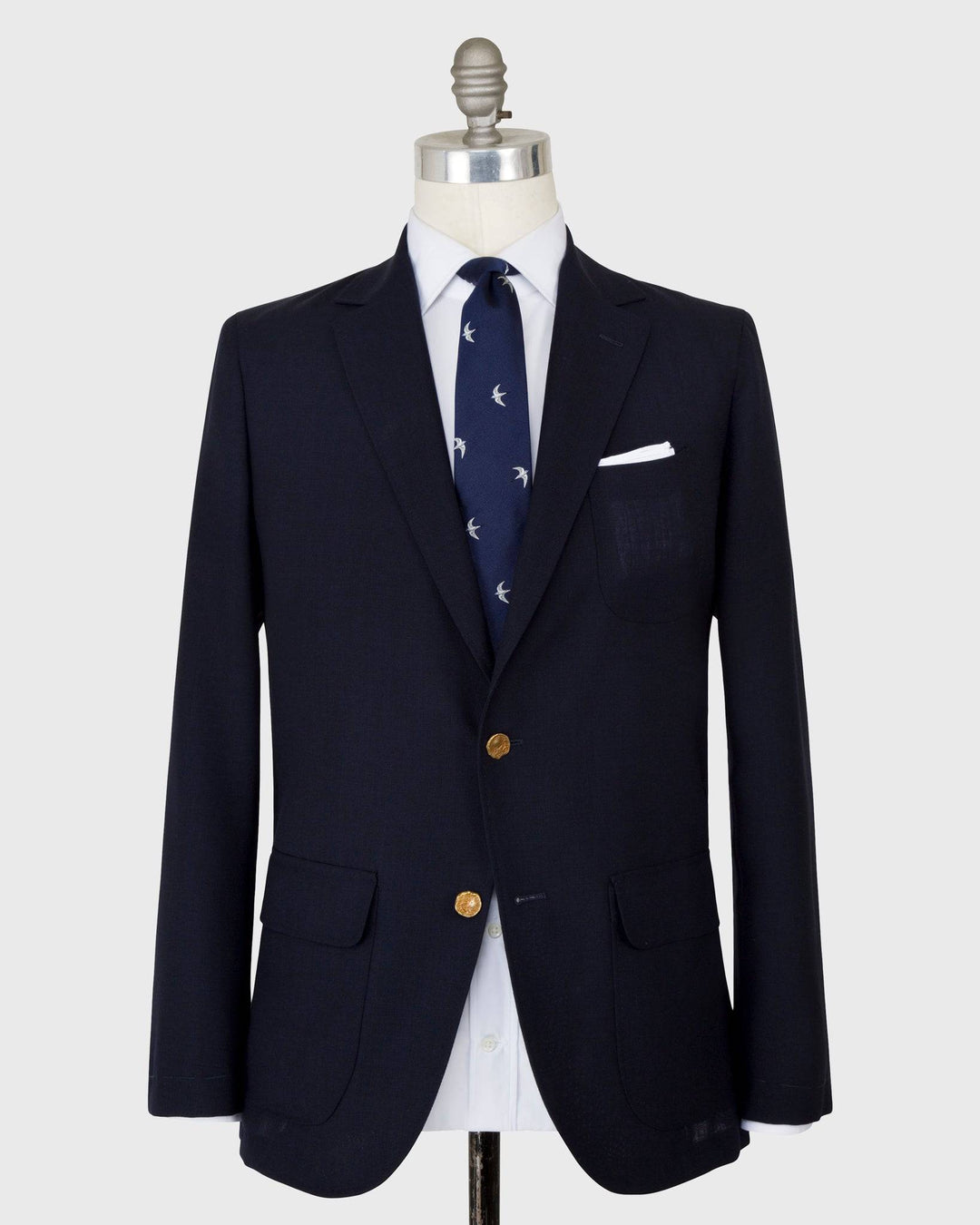 The Sid Mashburn Navy Ghost Blazer on a mannequin with white shirt and navy tie.