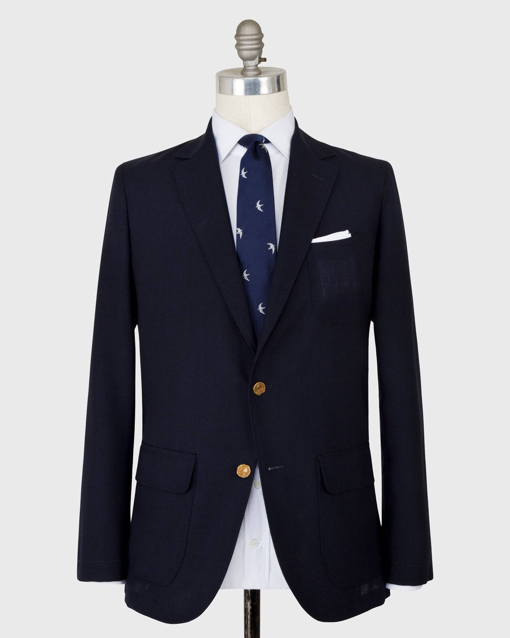 The Sid Mashburn Navy Ghost Blazer on a mannequin with white shirt and navy tie.